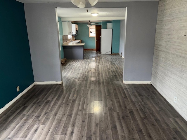 interior space featuring dark hardwood / wood-style flooring, sink, and ceiling fan