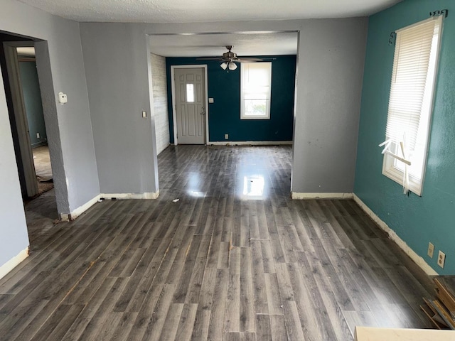 entryway with ceiling fan, dark hardwood / wood-style flooring, and a textured ceiling