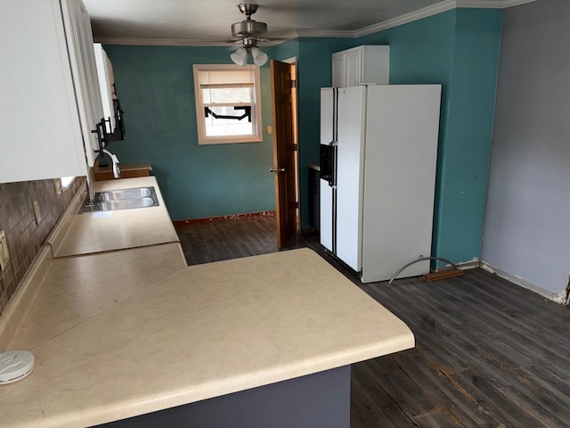 kitchen with sink, white fridge with ice dispenser, white cabinets, dark hardwood / wood-style flooring, and kitchen peninsula