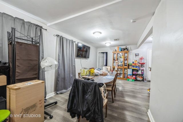 dining space with wood-type flooring