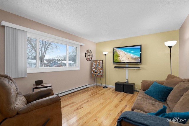 living room featuring a baseboard radiator, hardwood / wood-style floors, and a textured ceiling