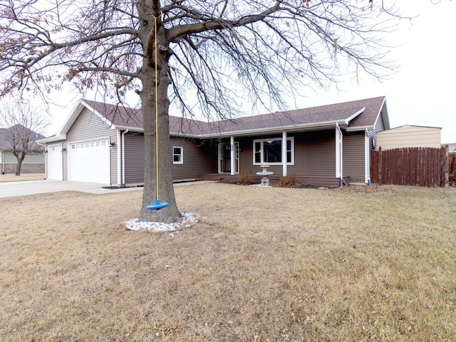 ranch-style house featuring a garage and a front yard