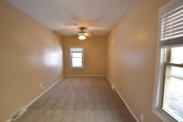 spare room featuring carpet floors and ceiling fan