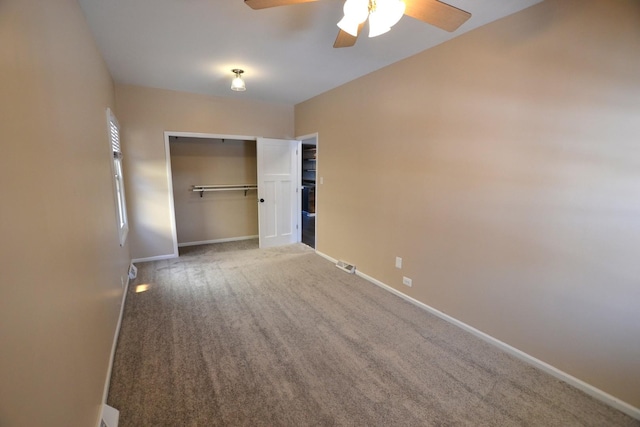 unfurnished bedroom with ceiling fan, carpet flooring, and a closet