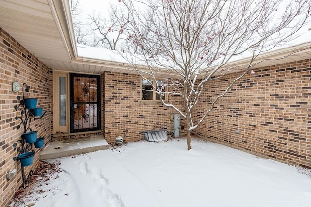 view of snow covered property entrance