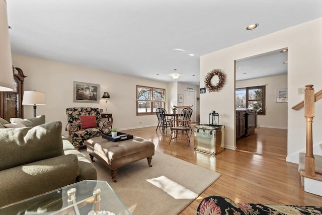 living area featuring light wood-type flooring, baseboards, a wealth of natural light, and recessed lighting