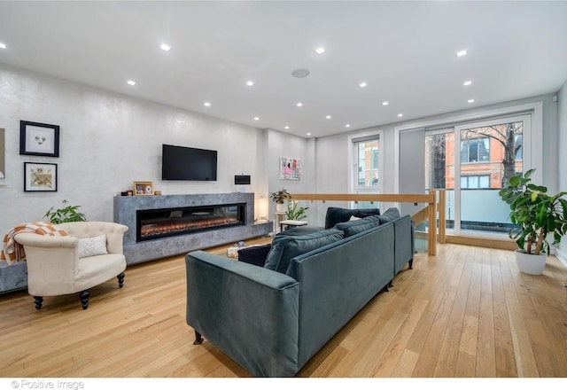 living room with a fireplace and light hardwood / wood-style flooring