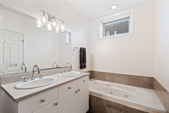 full bath with double vanity, a jetted tub, and a sink