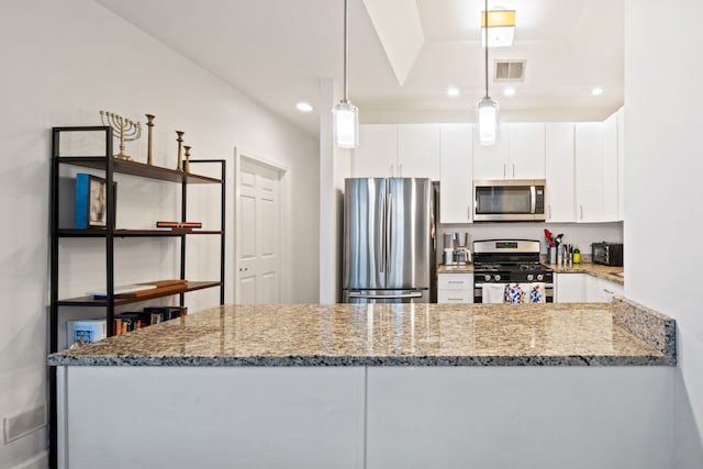 kitchen with a peninsula, visible vents, white cabinetry, hanging light fixtures, and appliances with stainless steel finishes