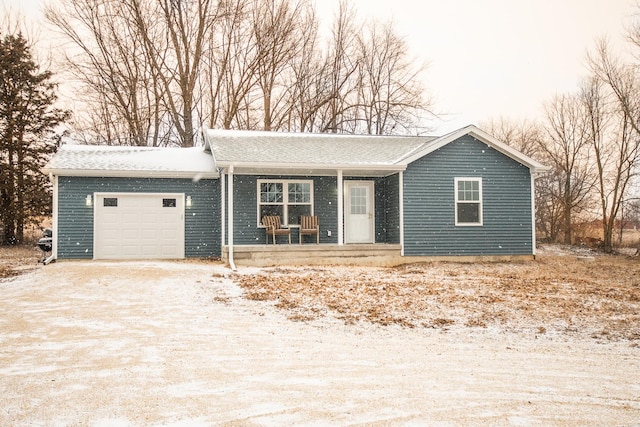 ranch-style home featuring a garage and covered porch