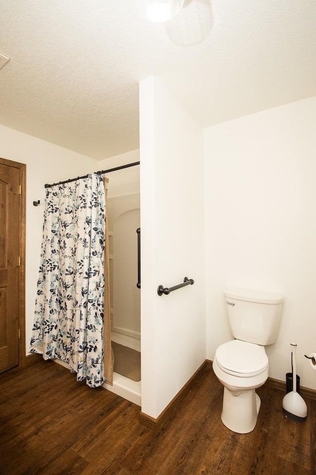 bathroom with walk in shower, wood-type flooring, and toilet