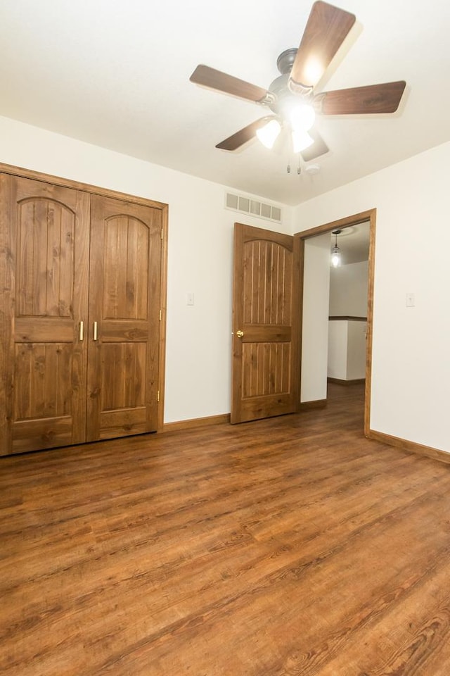 unfurnished bedroom featuring hardwood / wood-style flooring and ceiling fan