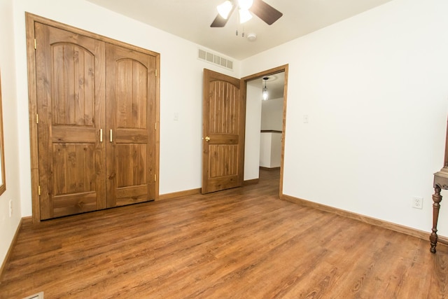 unfurnished bedroom with hardwood / wood-style floors and ceiling fan