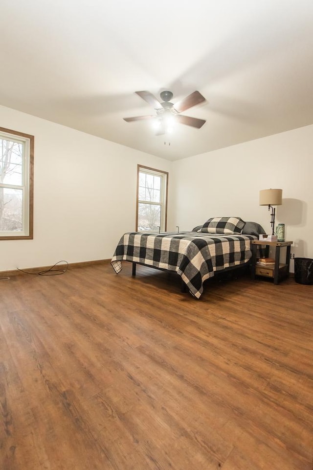 bedroom with hardwood / wood-style floors and ceiling fan