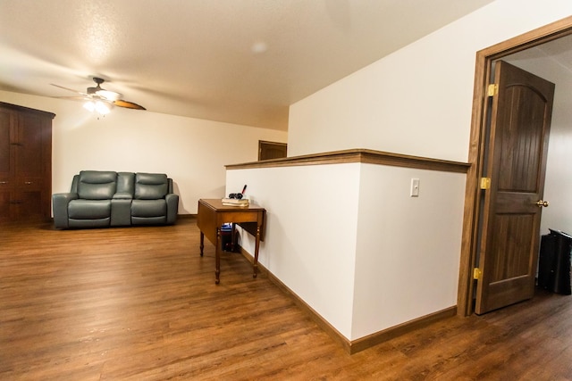 living room featuring hardwood / wood-style floors and ceiling fan