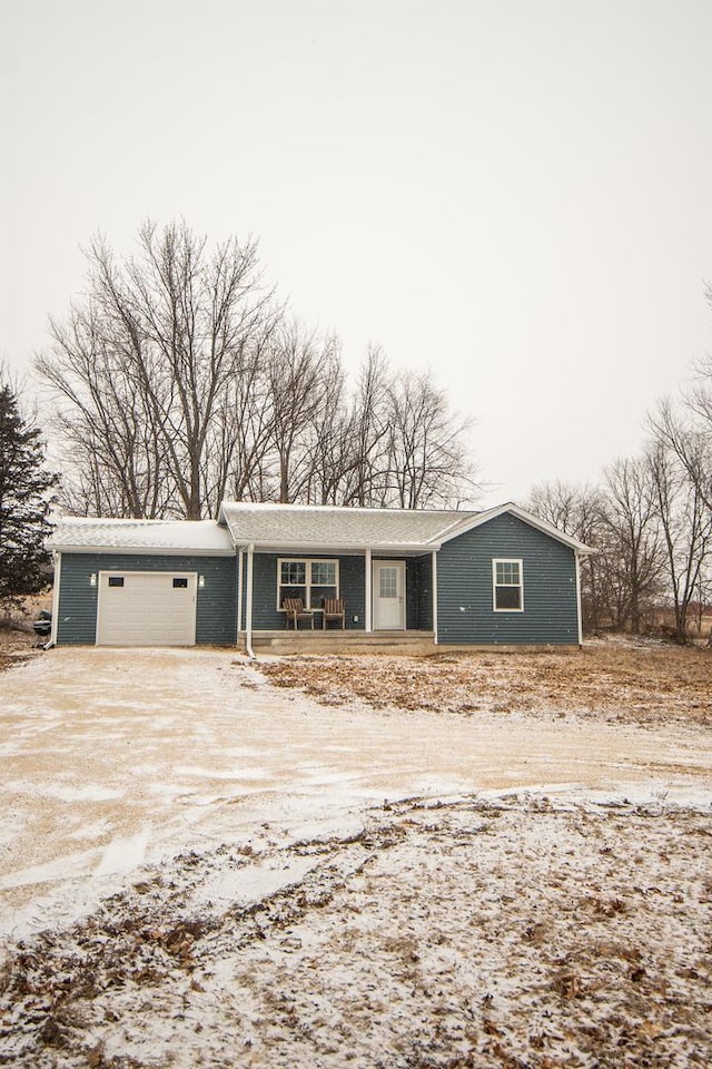 single story home featuring a garage and covered porch