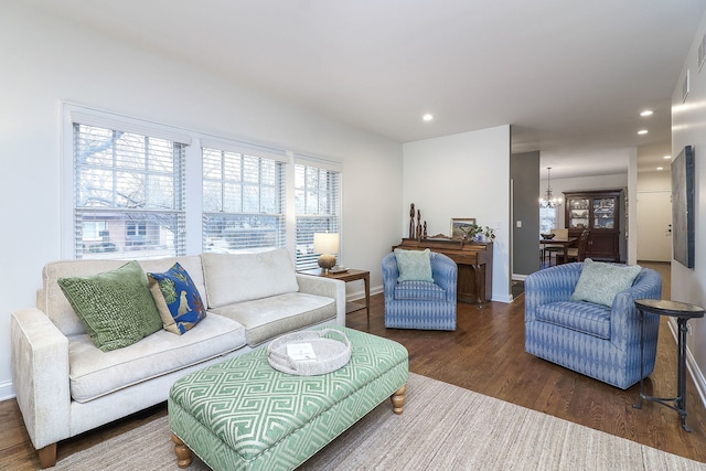 living room with a chandelier, recessed lighting, dark wood-style flooring, and baseboards