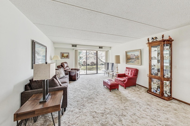 living area featuring baseboards, carpet, visible vents, and a textured ceiling