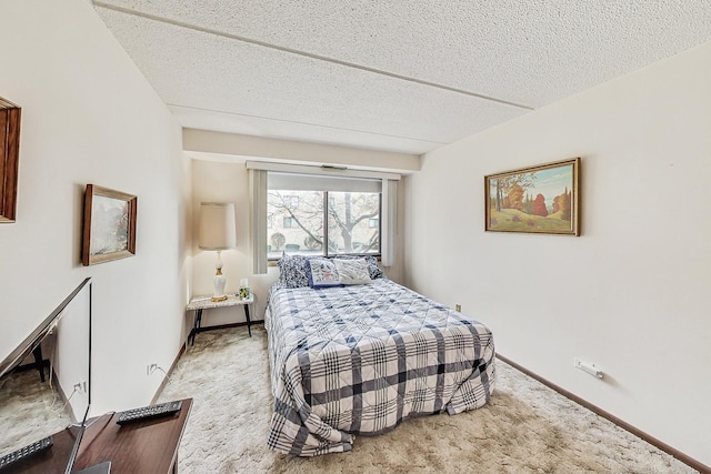 bedroom with baseboards, a textured ceiling, and light colored carpet