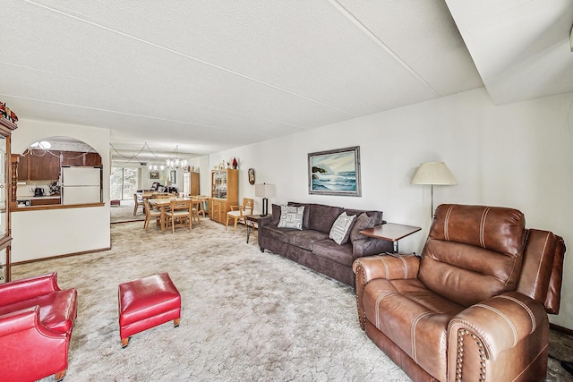 living area with carpet floors and a notable chandelier