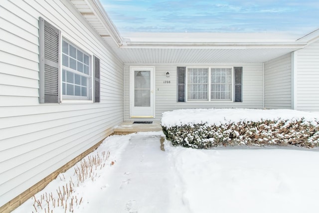 view of snow covered property entrance