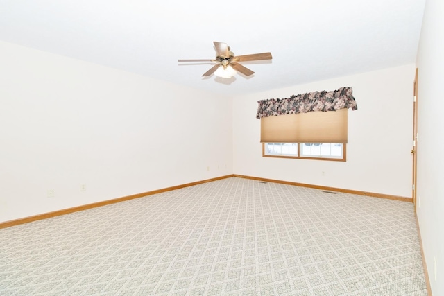 unfurnished room featuring light carpet, ceiling fan, and baseboards