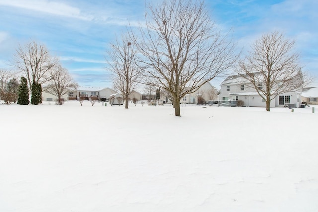 snowy yard featuring a residential view