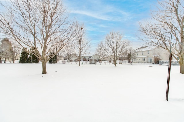 snowy yard featuring a residential view