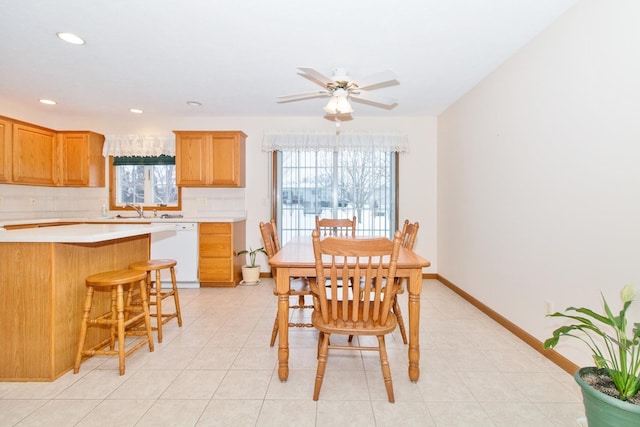 dining space featuring light tile patterned floors, ceiling fan, recessed lighting, and baseboards