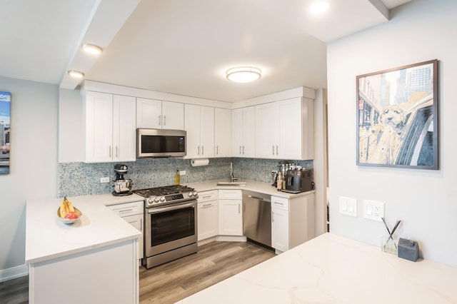 400 E Randolph St Unit 2410, Chicago, IL 60601 - kitchen featuring stainless steel appliances, light wood finished floors, tasteful backsplash, a sink, and recessed lighting