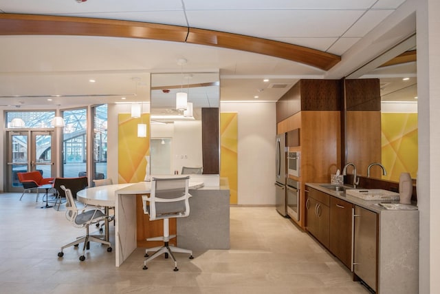 400 E Randolph St Unit 2410, Chicago, IL 60601 - kitchen with a sink, modern cabinets, freestanding refrigerator, pendant lighting, and a kitchen bar