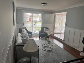 interior space with crown molding and dark wood-type flooring