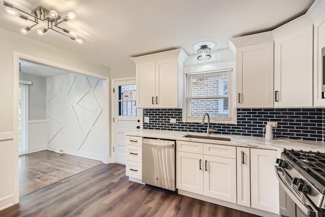 kitchen with a healthy amount of sunlight, stainless steel appliances, sink, and white cabinets