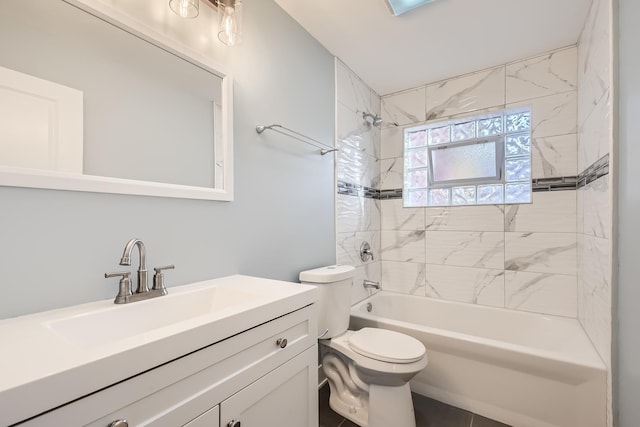 full bathroom with tiled shower / bath, vanity, and toilet