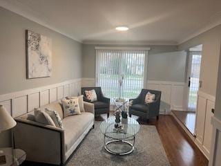 living room featuring crown molding and dark hardwood / wood-style flooring