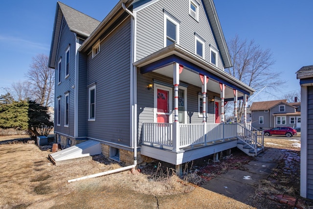 view of front of home featuring a porch and cooling unit