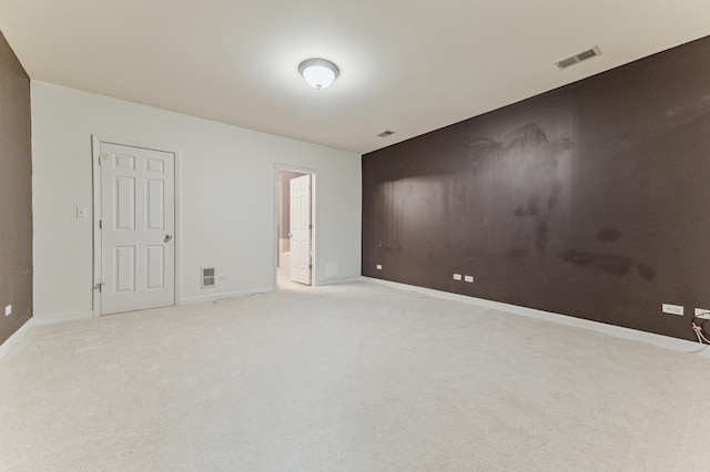 unfurnished room with light colored carpet