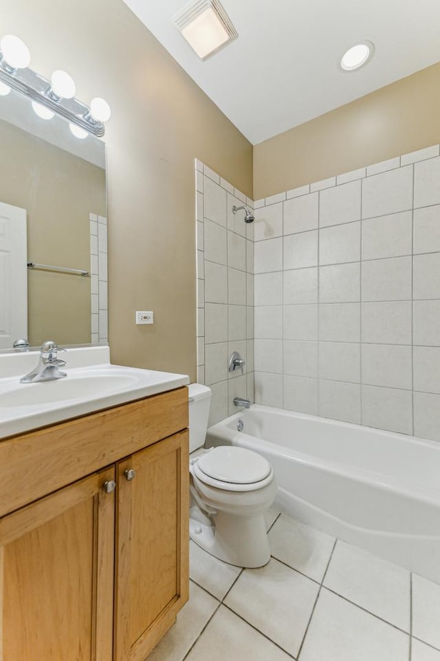 full bathroom featuring tiled shower / bath, vanity, toilet, and tile patterned flooring