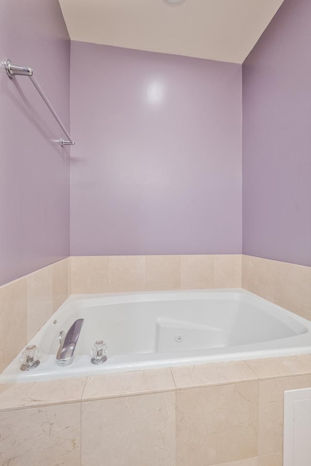 bathroom featuring a relaxing tiled tub