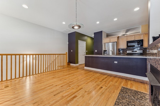 kitchen featuring light brown cabinetry, light hardwood / wood-style flooring, appliances with stainless steel finishes, pendant lighting, and decorative backsplash