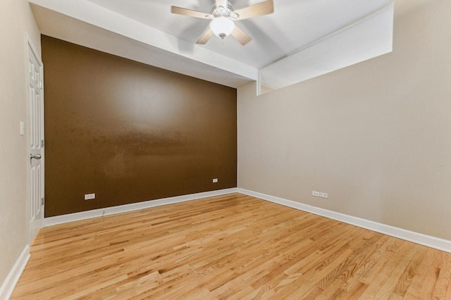 empty room featuring ceiling fan and light hardwood / wood-style flooring