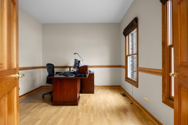 office with light wood-style flooring and baseboards