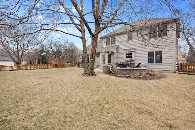 back of house featuring a lawn, a patio, and fence