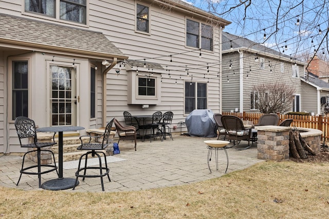 view of patio / terrace featuring a grill, a fire pit, and fence