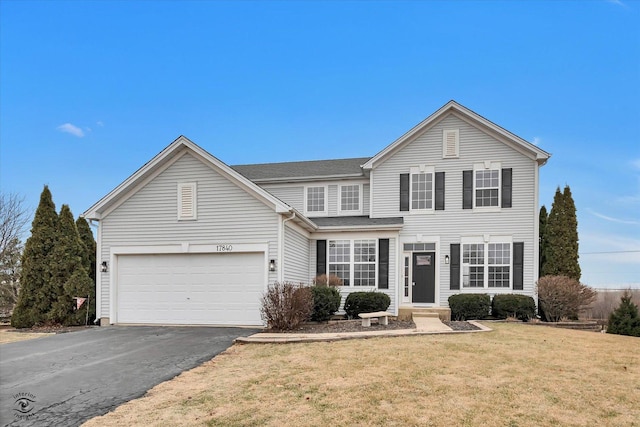 view of front of home with a garage and a front yard