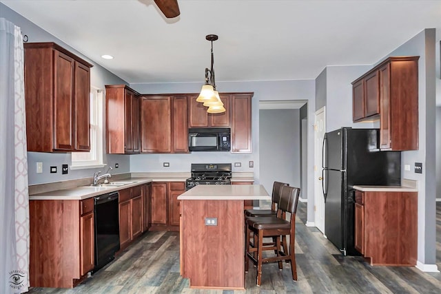 kitchen with a center island, black appliances, dark wood-type flooring, and a sink