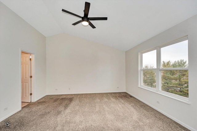 carpeted spare room with baseboards, ceiling fan, and vaulted ceiling