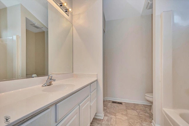 bathroom featuring vanity, toilet, baseboards, and visible vents