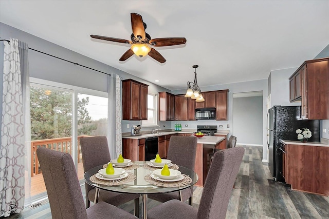 dining space with visible vents, baseboards, dark wood-type flooring, and ceiling fan