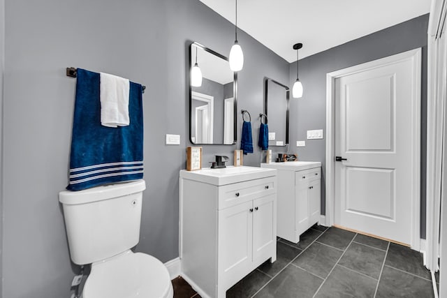 bathroom featuring vanity, tile patterned floors, and toilet